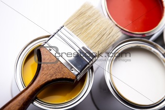 Cans of paint with paintbrush