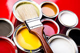 Cans of paint with paintbrush