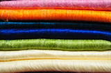 Stack of brightly coloured fluffy alpaca blankets