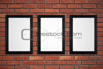 Frames on red brick wall
