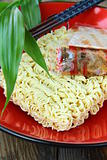 Instant  Asian noodle fast food with chopsticks in a red cup