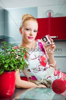Blond girl with glasses in interior of kitchen