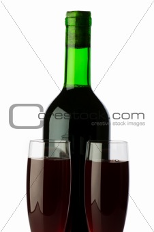 Bottle and wine glass on reflective background