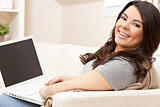 Happy Hispanic Woman Using Laptop Computer at Home