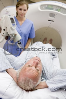 Nurse With Patient As They Prepare For A Computerized Axial Tomo