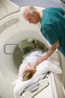 Doctor With Patient As They Prepare For A Computerized Axial Tom