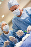 Surgeons Preparing Equipment For Surgery