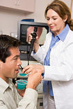 Doctor Performing Check-Up On Patient