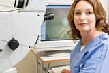 Portrait Of A Nurse Next To An Eye Exam Machine