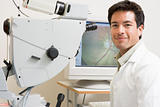 Portrait Of A Doctor Next To An Eye Exam Machine