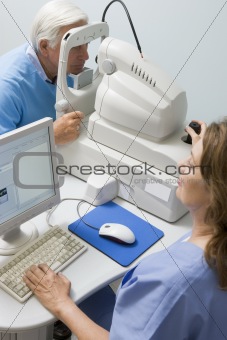 Nurse Checking Patient's Eyes