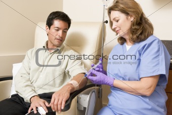 Nurse Giving Patient Injection Through Tube