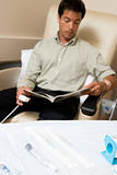 Patient Reading A Magazine While Being Monitored