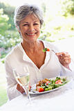 Senior Woman Eating An Al Fresco Lunch