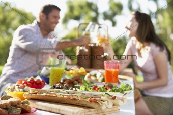 Couple Dining Al Fresco, Toasting Each Other