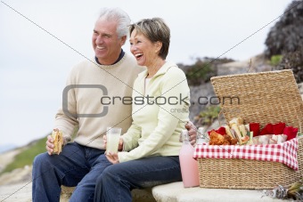 Couple Eating An Al Fresco Meal At The Beach