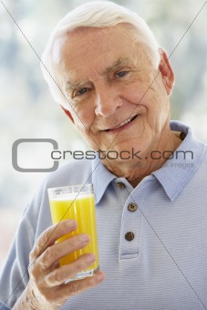 Man Smiling At Camera And Drinking Orange Juice