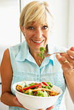 Middle Aged Woman Eating A Healthy Salad
