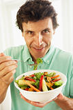 Mid Adult Man Eating A Healthy Salad
