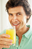 Mid Adult Man Drinking A Glass Of Orange Juice