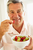 Middle Aged Man Eating Fresh Fruit