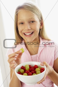 Young Girl Eating Fresh Fruit Salad