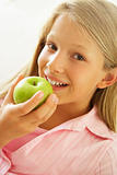 Young Girl Eating An Apple