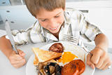 Young Boy Eating Unhealthy Fried Breakfast