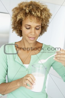 Mid Adult Woman Holding Dietary Supplements