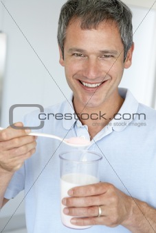 Middle Aged Man Holding Dietary Supplements