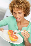 Mid Adult Woman Eating Fresh Grapefruit