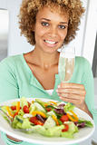 Mid Adult Woman Holding A Wine Glass And Fresh Salad