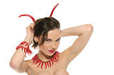 Sexy woman with jewelry and horns of red hot pepper
