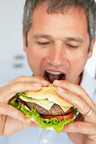 Middle Aged Man Eating A Burger
