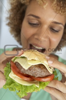 Mid Adult Woman Eating A Burger
