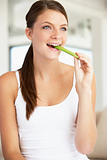 Young Woman Eating Celery Sticks