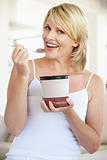 Mid Adult Woman Eating Chocolate Ice-Cream And Smiling At The Ca
