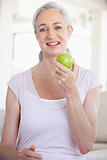 Senior Woman Eating Green Apple