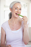 Senior Woman Eating A Celery Stick