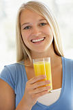 Teenage Girl Drinking A Glass Of Orange Juice