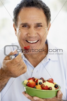 Senior Man Eating Fresh Fruit Salad