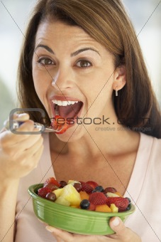 Mid Adult Woman Eating A Fresh Fruit Salad