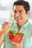 Mid Adult Man Holding A Bowl Of Salad, Smiling At The Camera