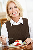 Senior Woman Eating Cheesecake