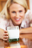 Mid Adult Woman Holding Glass Of Milk, Smiling At Camera