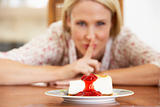 Mid Adult Woman Looking At Cheesecake