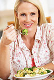 Mid Adult Woman Eating A Healthy Meal