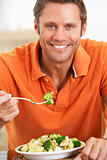 Middle Aged Man Eating A Healthy Meal, Smiling At The Camera