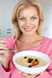 Mid Adult Woman Eating Porridge With Fresh Fruit