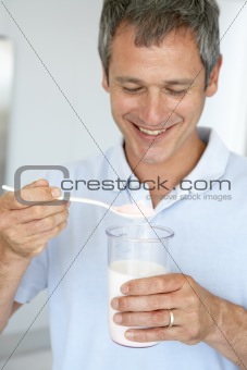 Middle Aged Man Preparing A Dietary Supplement